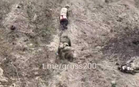 Occupier on battlefield crosses himself twice and then crawls behind his naked henchman. VIDEO