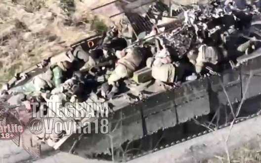 Dead occupiers ride on armor of survivor after being hit by APC-1 kamikaze drone. VIDEO